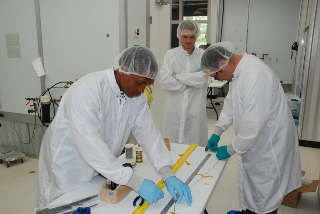 Students Demetrius Tuggle, David Conran, and Joe Smolsky assemble a wiring harness for the NEID ECS.